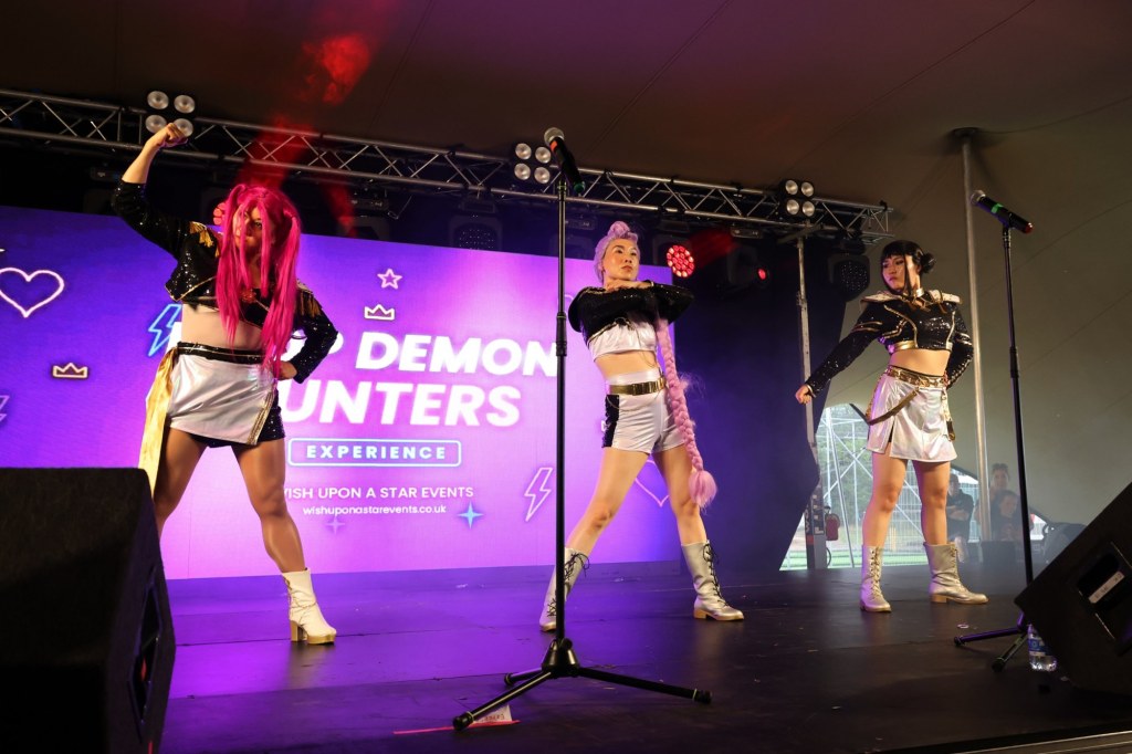 K-pop Demon Hunters tribute show performing on a festival stage